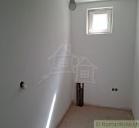 A small room in a family house with a window and preparation for installations.