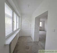 The interior of a family house with white walls and windows with blinds.