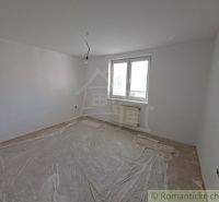 An empty room in a family house, white walls, plastic covering on the floor.