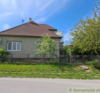 A family house in Orešany with a garden and a decorative fence on a sunny street.