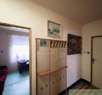 A hallway in a family house with a wardrobe and a view of the room.