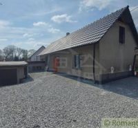 A family house in Sobotište with a concrete courtyard and an adjacent garage.