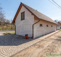 A family house in Sobotište with a paved driveway, surrounded by greenery and trees.