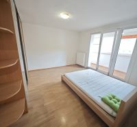 Bright bedroom in a 3-room apartment with a bed and wood-decor flooring.