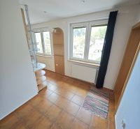 A room in a 3-room apartment with tiles, windows, and shelves.