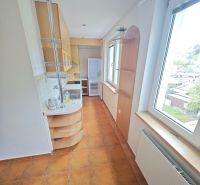 A cozy kitchen with a view and tiles in a 3-room apartment.