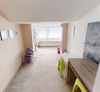 Children's room in a family house with carpet, furniture, and children's drawings.