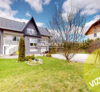 A family house in Vitanová with a nicely maintained garden and a view of the surrounding houses.