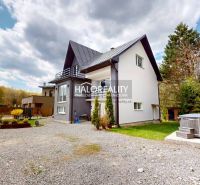 A family house in Vitanová surrounded by a garden and a paved access road.