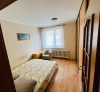 Bedroom with a double bed and wooden decor flooring in a 3-room apartment.