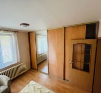White wall, wardrobe with sliding doors, wooden decor flooring, 3-room apartment.