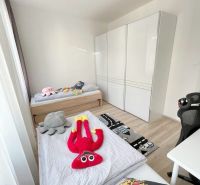Children's room in a 3-room apartment with toys and a floor with a wooden decor.