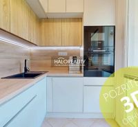 A kitchen in a 3-room apartment with light cabinets and a wood-patterned floor.