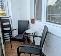 A balcony in Dubnica nad Váhom on Centrum I with two chairs and a table.