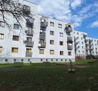 An apartment building on Majakovského Street in Prešov surrounded by greenery and a parking lot.