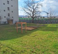 A courtyard by a 2-room apartment on Majakovského in Prešov with a lawn and trees.
