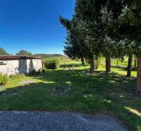 The garden at the family house on Mikulášov in Lakšárska Nová Ves with large trees.