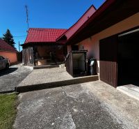 A family house in Mikulášov in Lakšárska Nová Ves with a red roof and a yard.