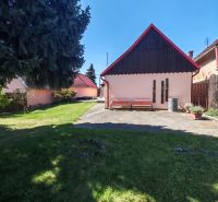 A family house on Mikulášov Street in Lakšárska Nová Ves with a landscaped garden and benches.