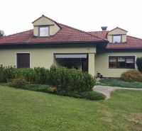 A family house in Trebostovo with a garden, a sloped roof, and a green facade.