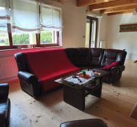 Living room in a family house with leather sofas and a wooden decor floor.