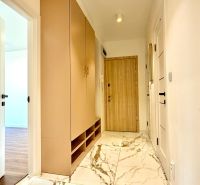 A hallway in a 3-room apartment with white doors and a marble-patterned floor.