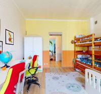 Children's room with a bunk bed, a desk, and decorations in a family house.