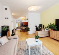 Beautiful living space with wood-patterned flooring in a family house.
