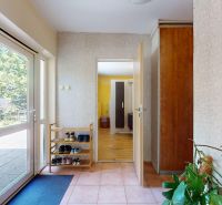 Interior of a family house with a shoe rack and access to the terrace.