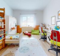 A children's room in a family house with a bunk bed and a desk.