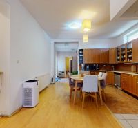 Kitchen and dining room in a family house with a wooden decor floor, long dining table.