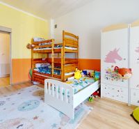 Children's room in a family house with a bunk bed and a decorated wardrobe, floor with wooden decor.