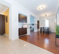 Family house with a wooden decor floor, bright interior, and modern furniture.