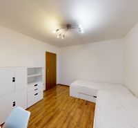 Bedroom in a 3-room apartment with white furniture and a wooden decor floor.