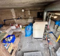 Boiler room in a family house with a boiler and piping, storage space for materials.