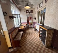 The interior of a family house with retro furniture and checkered flooring.