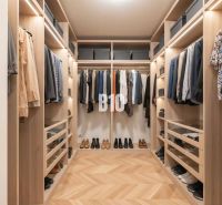 A wardrobe with a wooden decor floor, containing clothes and shoes in a 4-room apartment.