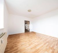 A bright room with walls in a 4-room apartment and a floor with a wooden decor.