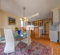 Dining area with flowers on the table in the kitchen of a family house.