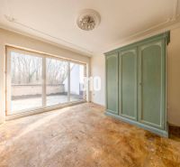 The interior of a room in a family house with a large green wardrobe and glass doors.