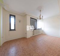 Living room in a family house with a chandelier and wooden decor flooring.