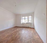 Bright room with wood-decor flooring in a 3-room apartment for rent.