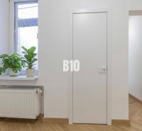 Interior of a 3-room apartment with plants on the windowsill and a floor with a wooden decor.