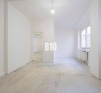 An empty 3-room apartment interior with white walls and a large window.
