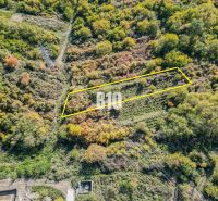Aerial view of a plot in the Gardens of Bratislava III surrounded by wooded landscape.
