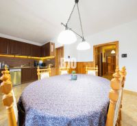 A dining room in a family house with wooden decor and a decorated table.