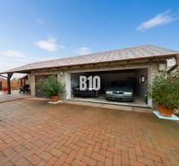 A family house in Štvrtok na Ostrove with a garage for two cars and a paved courtyard.