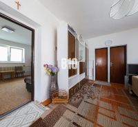 Living room in a family house with furniture and a carpet.