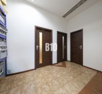 Commercial premises with ceramic flooring and shelves for storage boxes.