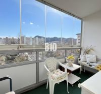 A furnished balcony in a 3-room apartment with a view of Ružomberok and the apartment blocks.